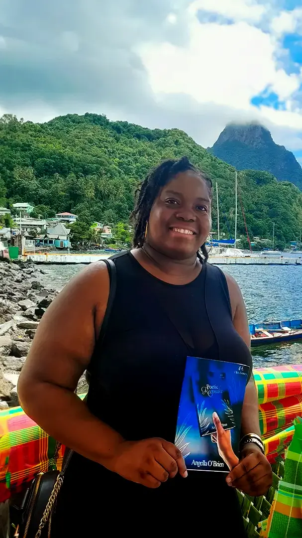 Angella holding Poetic Keepsake on a beach